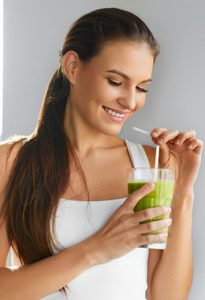 girl drinking green juice